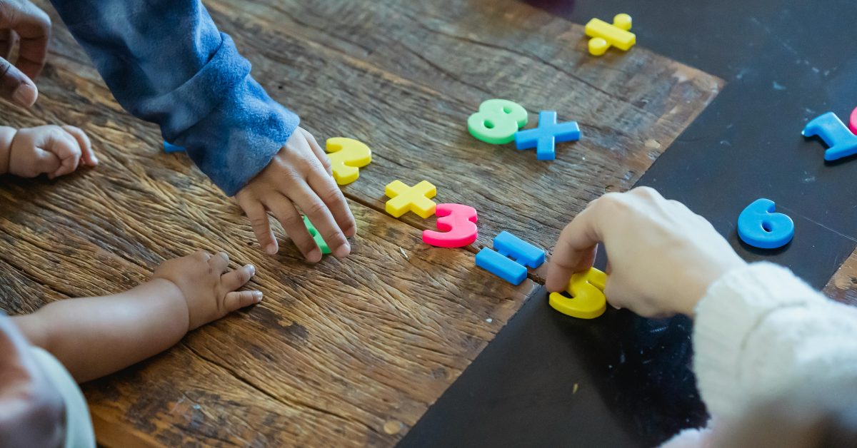 Children playing with plastic numbers
