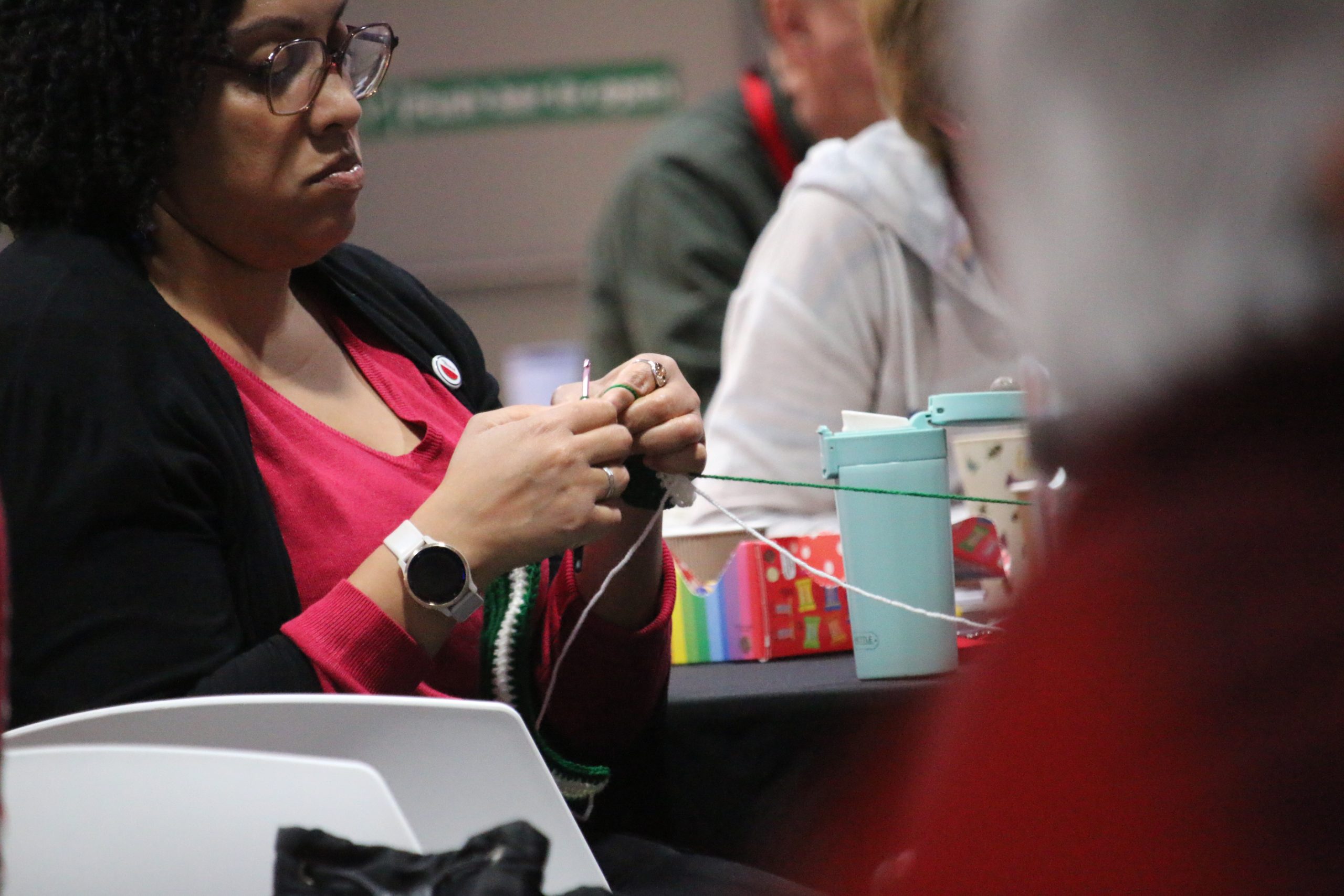A participant knitting at ForGood25