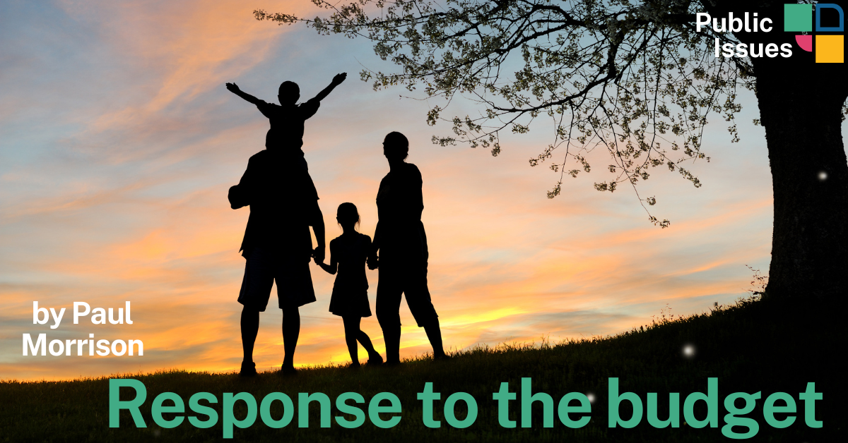 Silhouette of a family standing under a tree at sunset, with one child raised on an adult’s shoulders. Text on the image reads “Response to the budget” in large green letters and “by Paul Morrison” in white. The Public Issues logo appears in the top right corner.