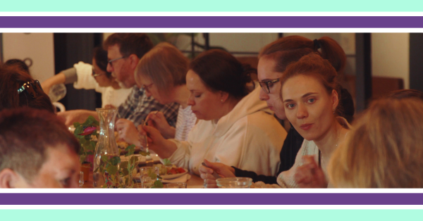 A group of people eating food at a table together.